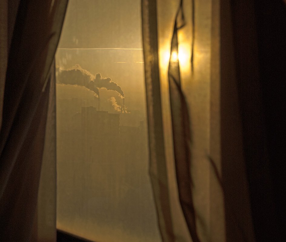 The first rays of day. The sun is visible in the folds of the curtain, the horizon line clearly drawned.